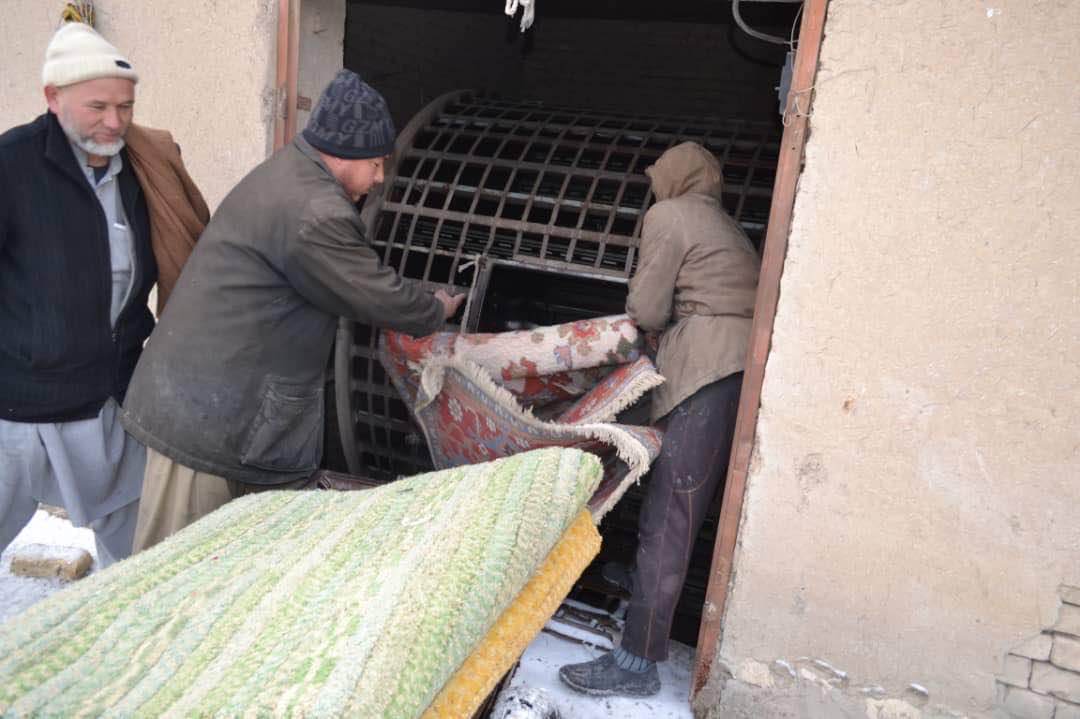 Artisans washing handwoven rugs